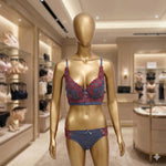 Mannequin wearing a blue and red bra and panties set in a store setting